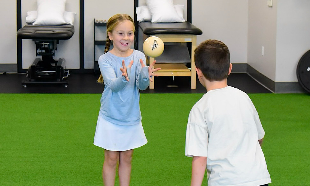 Children Playing with Ball in Physical Therapy Gym in Boise, ID
